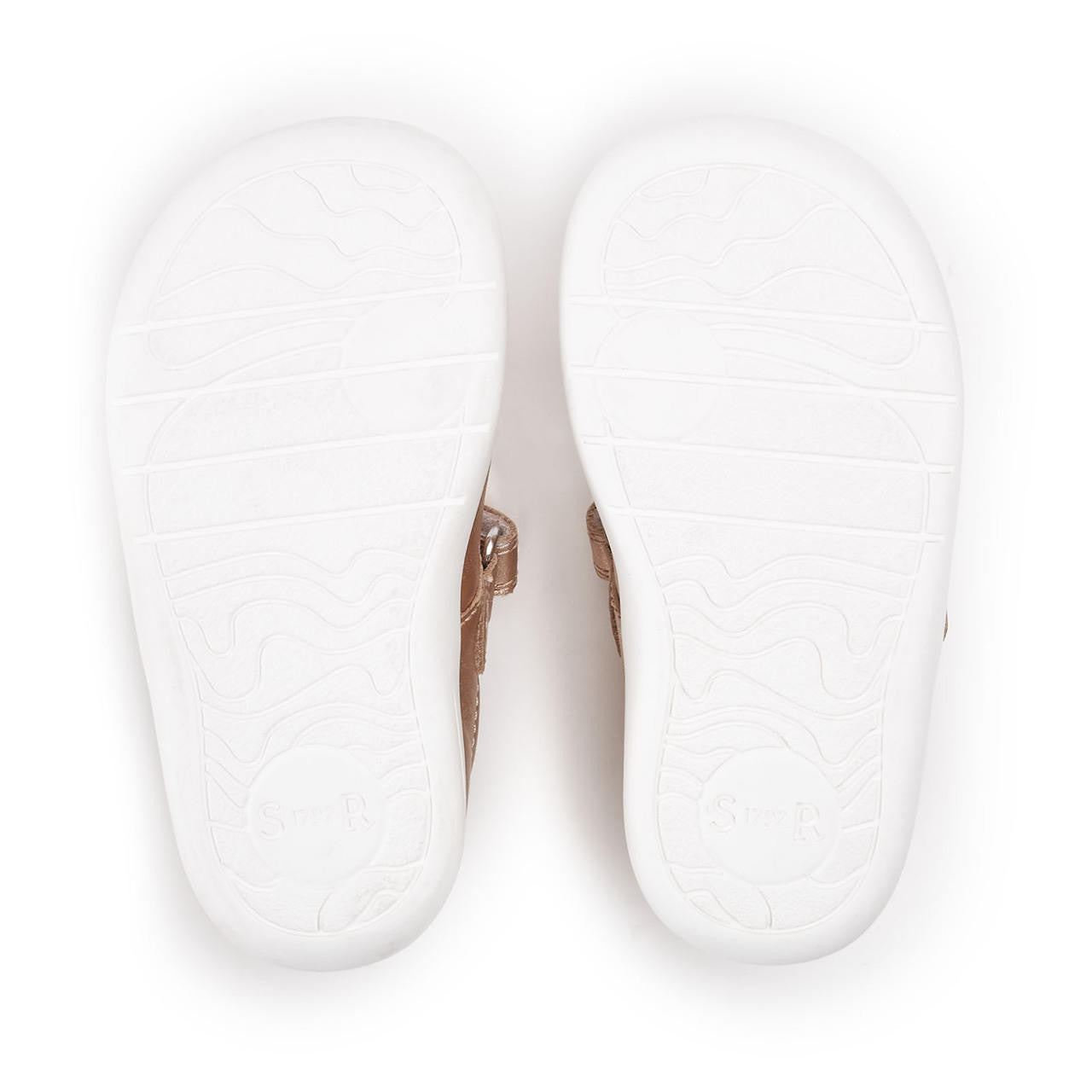 A pair of girls T-Bar shoes by Start- Rite, style Puzzle, in Rose Gold leather with Velcro fastening. View of white sole.