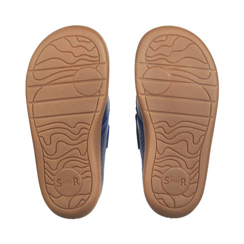 A pair of boys ankle boots by Start-Rite, style Totter, in navy leather with light tan trim and sole unit.Velcro fastening. View of soles.