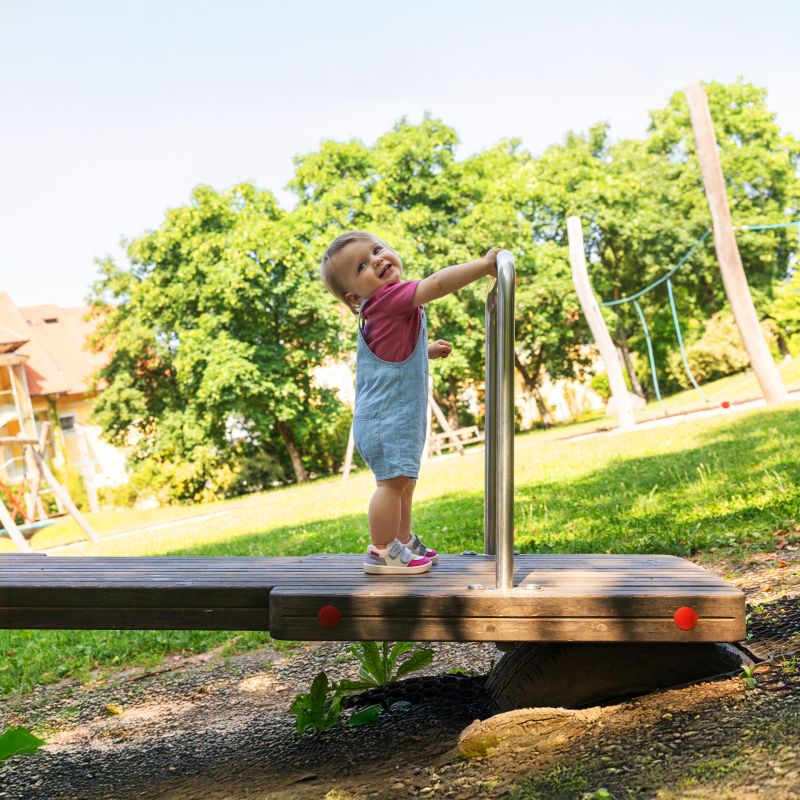 A girls casual trainer by Superfit, style Supies in pink/multicolour with pink stiching detail on side and two velcro straps. Image of child wearing shoes on playground equipment.