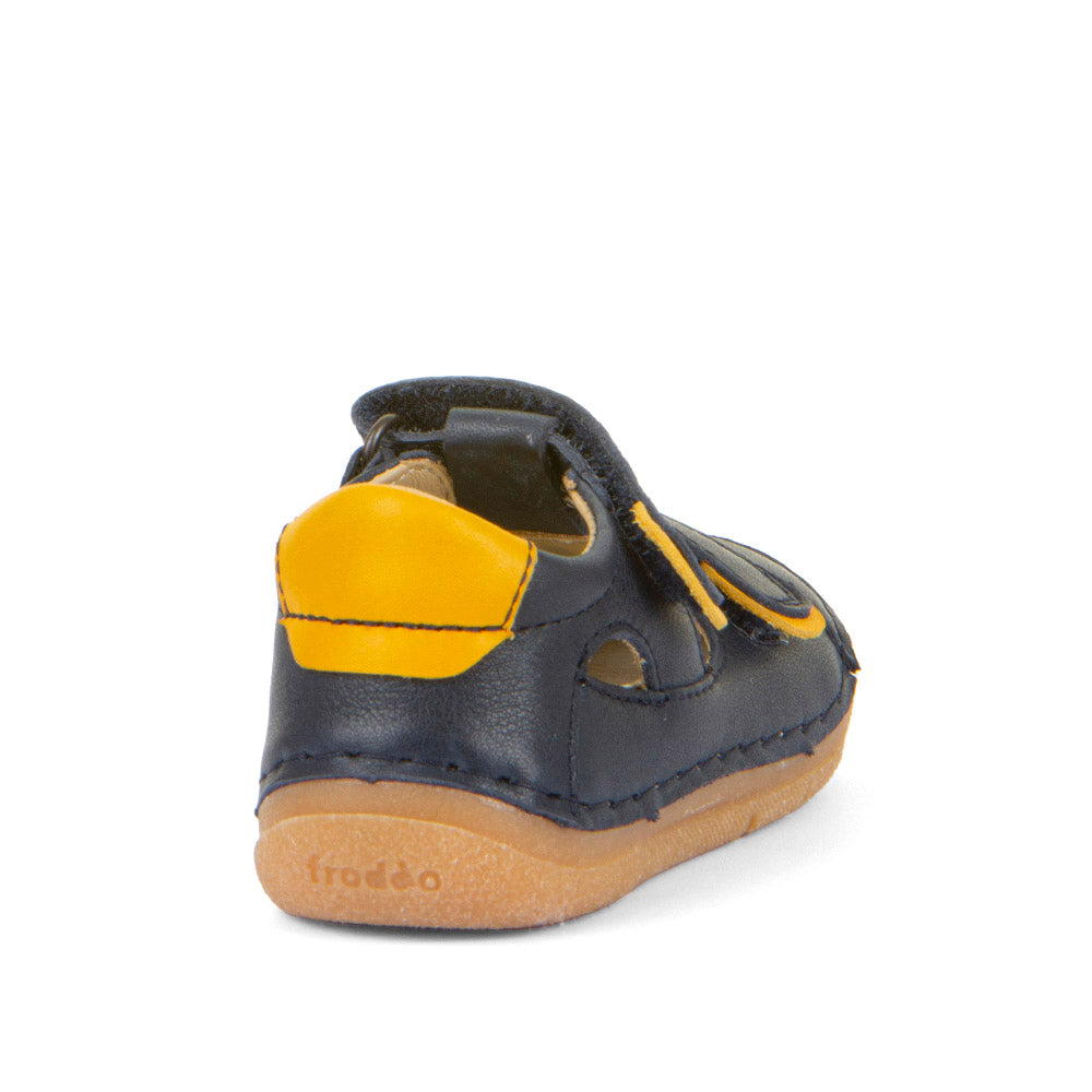A boys closed toe sandal by Froddo, style Paix Double G2150198, in blue with yellow trim and double velcro fastening. Angled back view.
