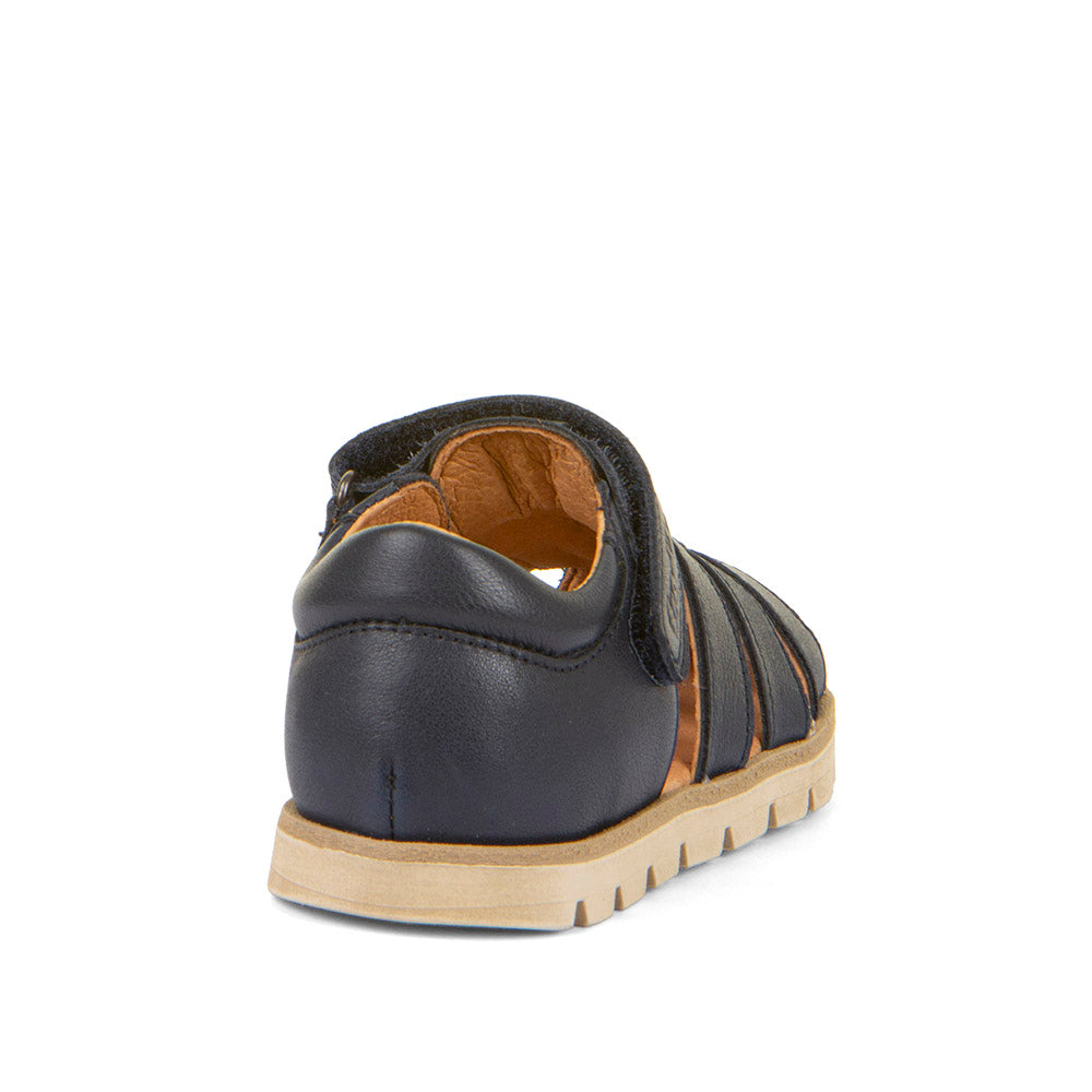 A unisex closed toe sandal by Froddo,style Keko G3150287 in navy with velcro fastening. Angled view rom back.