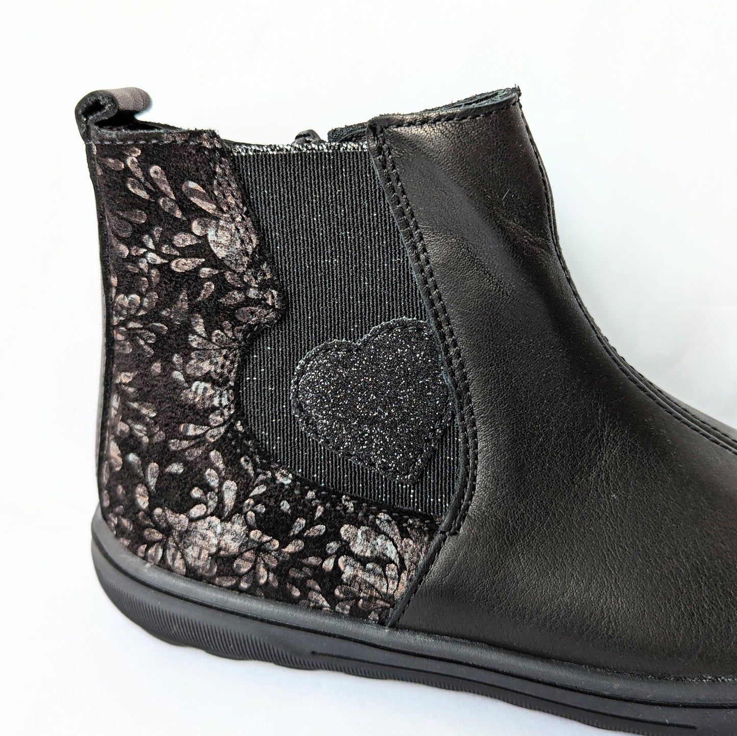 A girls ankle boot by Bopy, style Sonate, in black leather/black gold print nubuck with zip fastening. Close up of heart detail/gold print on elastic gusset