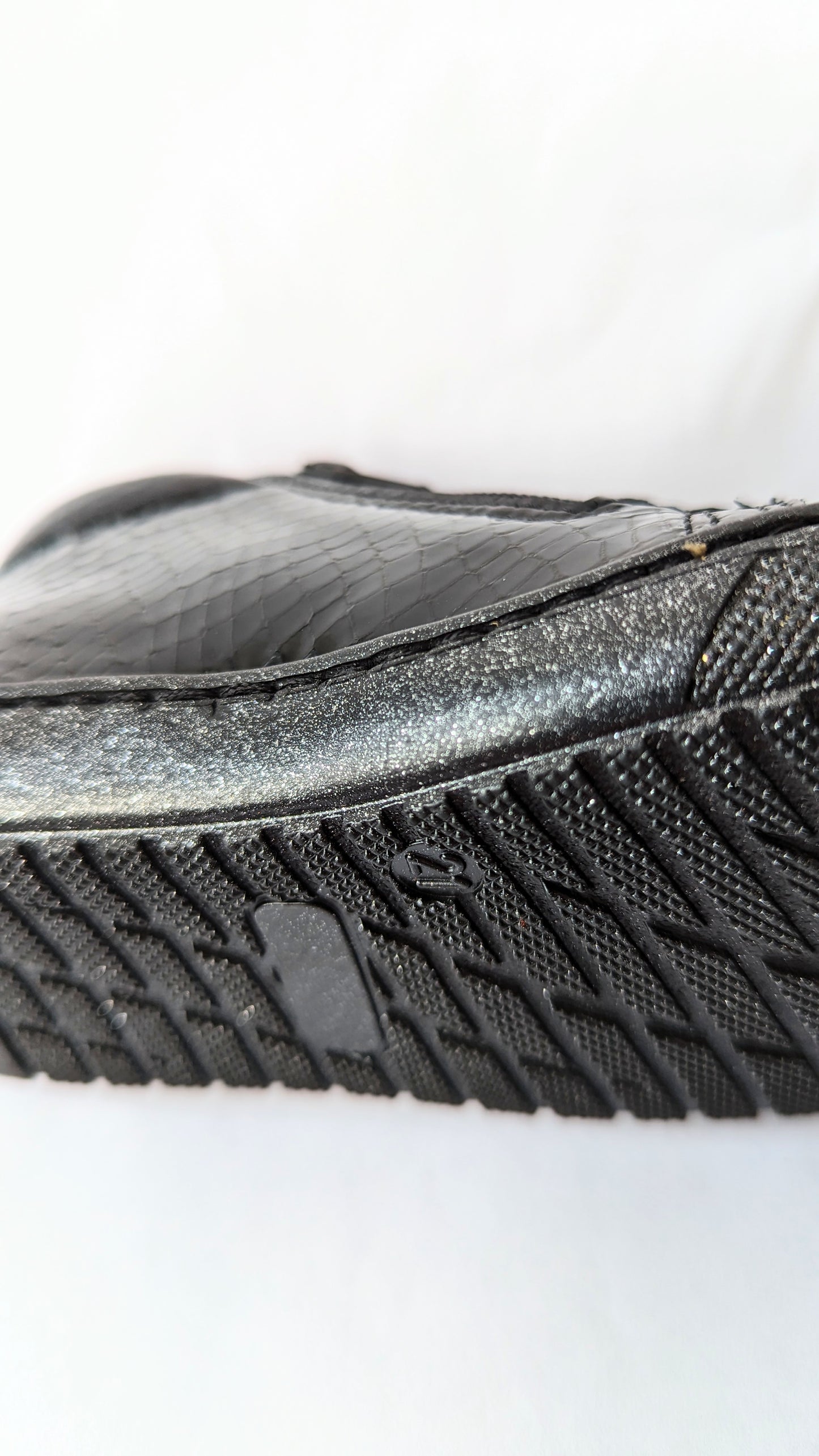 A girls ankle boot by Bopy, style Joseva, in black patent leather croc with toe bumper and zip/glitter lace fastening. Close up of sole.