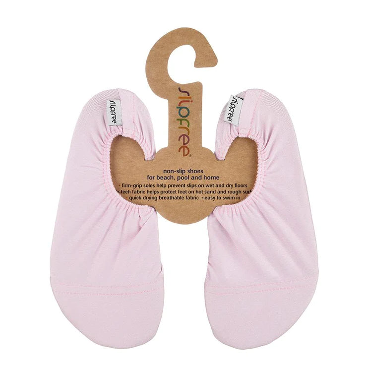 A pair of girls non-slip swim shoes by Slipfree, style Pale Pink, in pink. Front view.