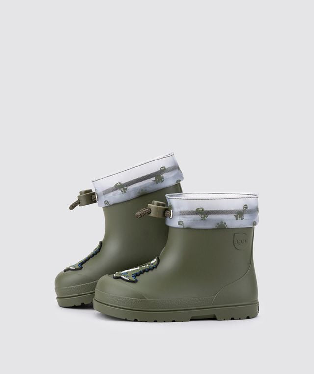 A pair of unisex wellies by Igor, style W10323-042 Mendi Dino, in Khaki with dino detail and toggle fastening. Left side view of a pair.