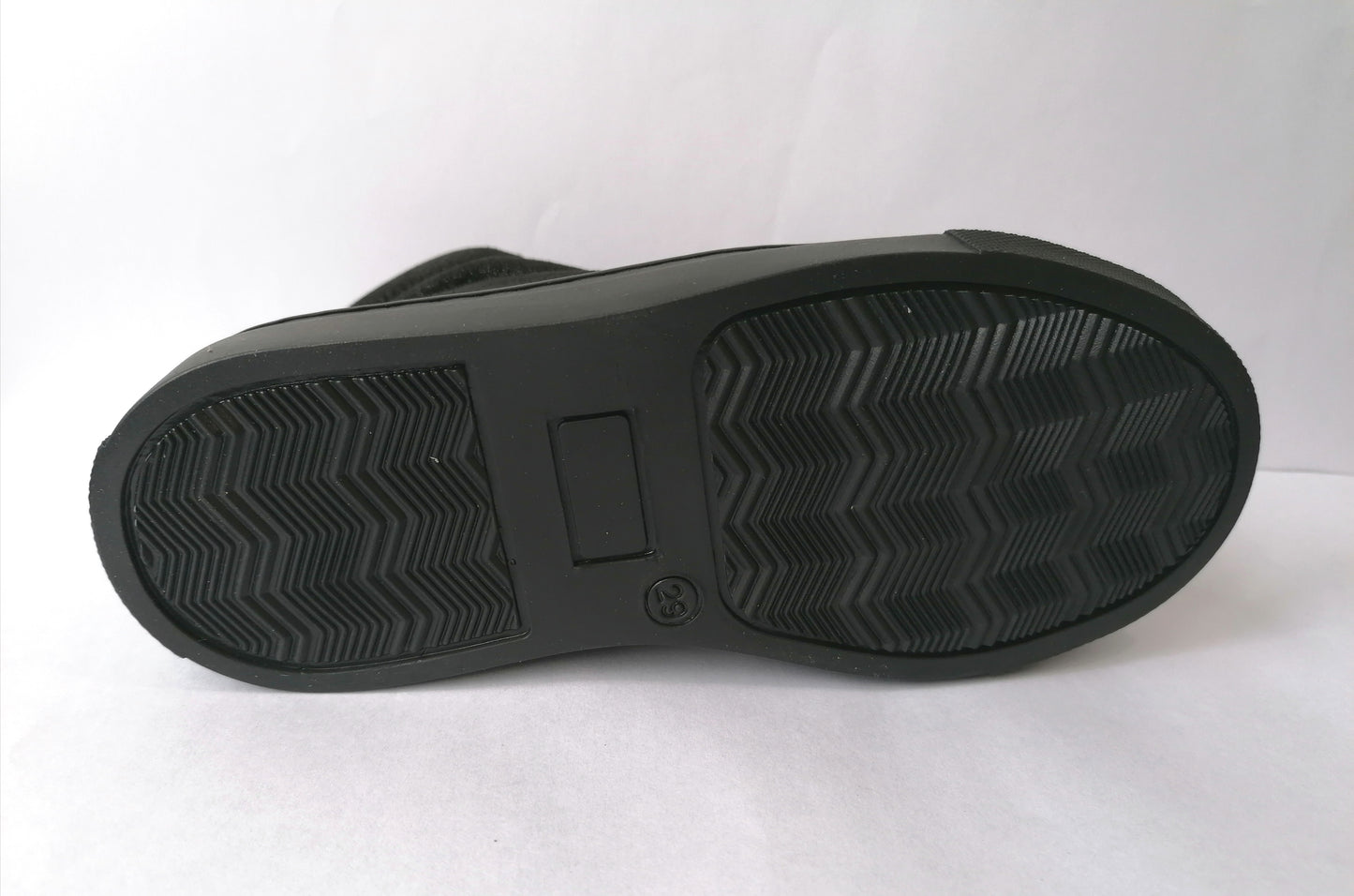 A girls casual boot by Petasil, style Gracie 2,in black patent and nubuck with lace and zip fastening. Sole view.