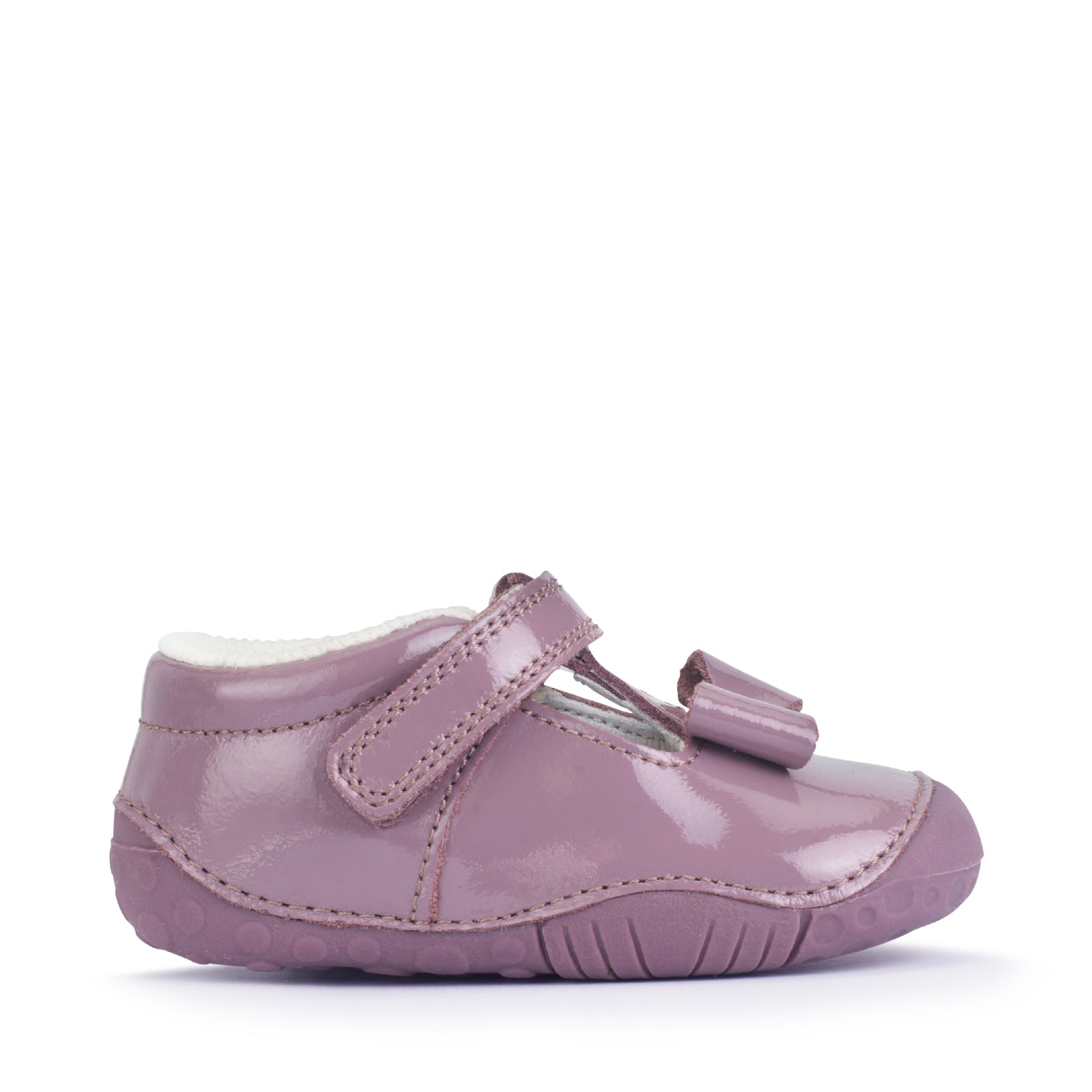 A girls shoe by Start-Rite, stye Wiggle, in mauve with bow detail, with heel and toe bumpers and t bar with velcro strap. Right side view