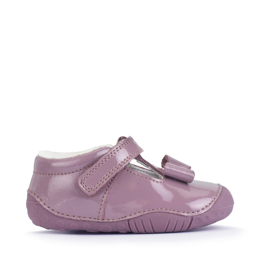 A girls shoe by Start-Rite, stye Wiggle, in mauve with bow detail, with heel and toe bumpers and t bar with velcro strap. Right side view