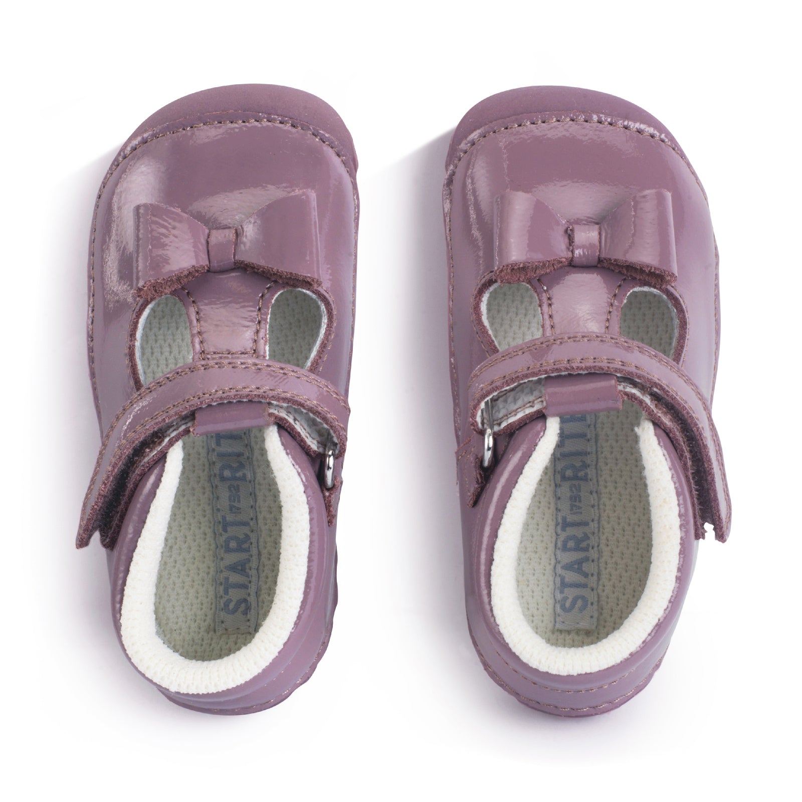 A girls shoe by Start-Rite, stye Wiggle, in mauve with bow detail, with heel and toe bumpers and t bar with velcro strap. Top view of pair