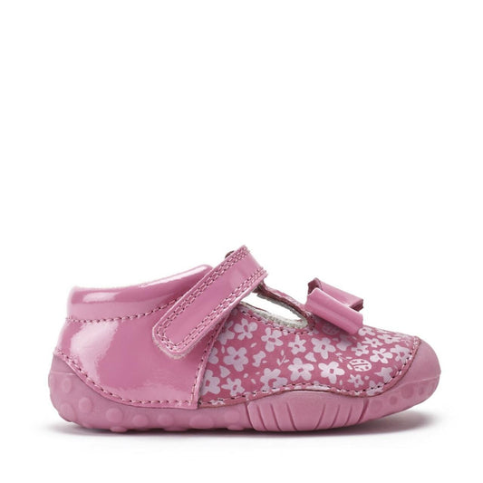 A girls T-Bar pre-walker by Start-Rite, style Wiggle in pink patent and floral nubuck with bow detail and toe bumper. Velcro fastening. Right side view.