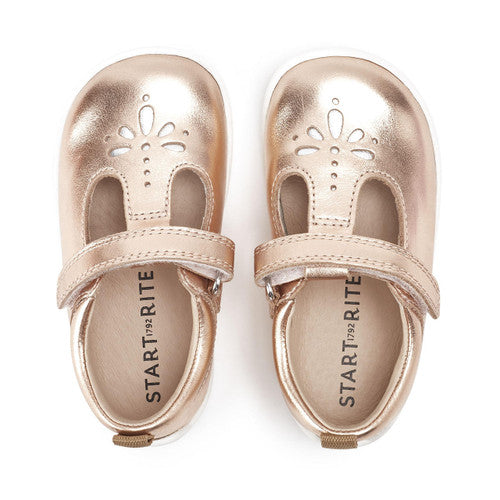 A pair of girls T-Bar shoes by Start- Rite, style Puzzle, in Rose Gold leather with Velcro fastening. View from above.