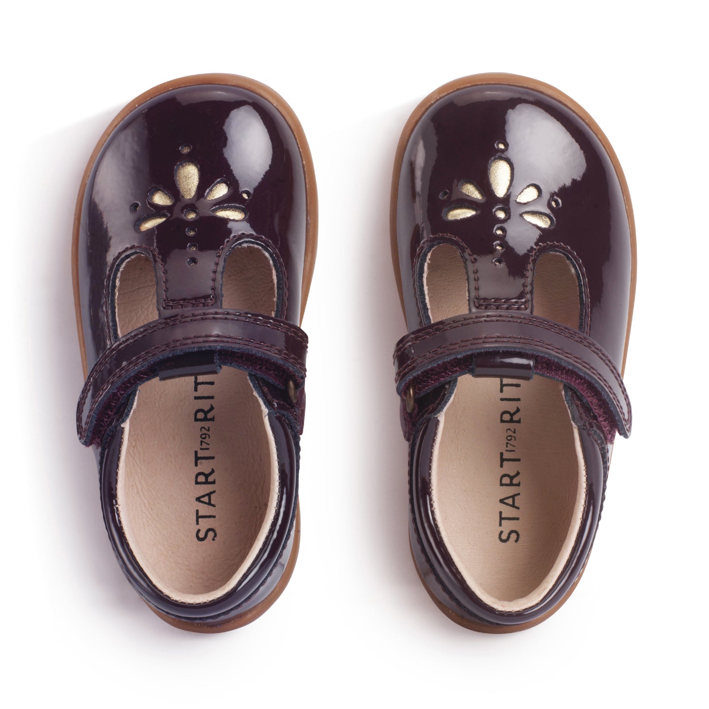 A girls shoe by Start-Rite, stye Puzzle, in burgundy with heel and toe bumpers and t bar with velcro strap. Top view of pair
