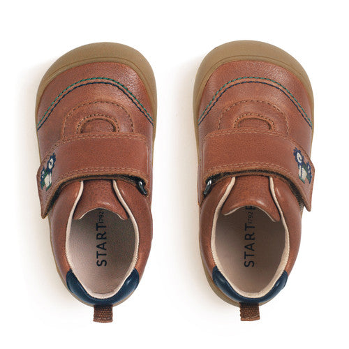 A boys casual shoe by Start-Rite, style Harvest, in tan with heel and toe bumpers and tractor detail to the velcro fastening. Above view of a pair.