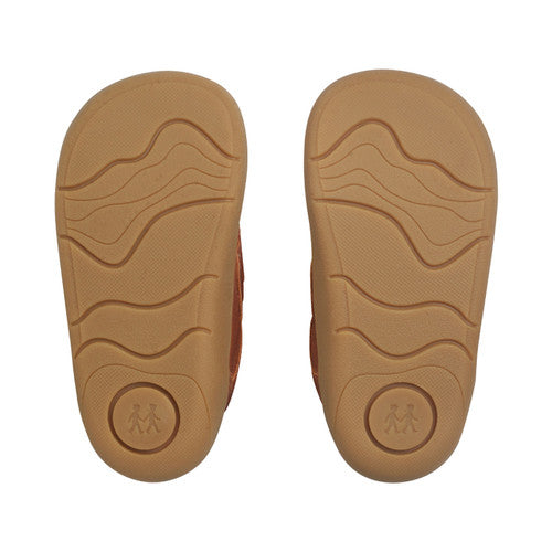A boys casual shoe by Start-Rite, style Harvest, in tan with heel and toe bumpers and tractor detail to the velcro fastening. View of soles of a pair.