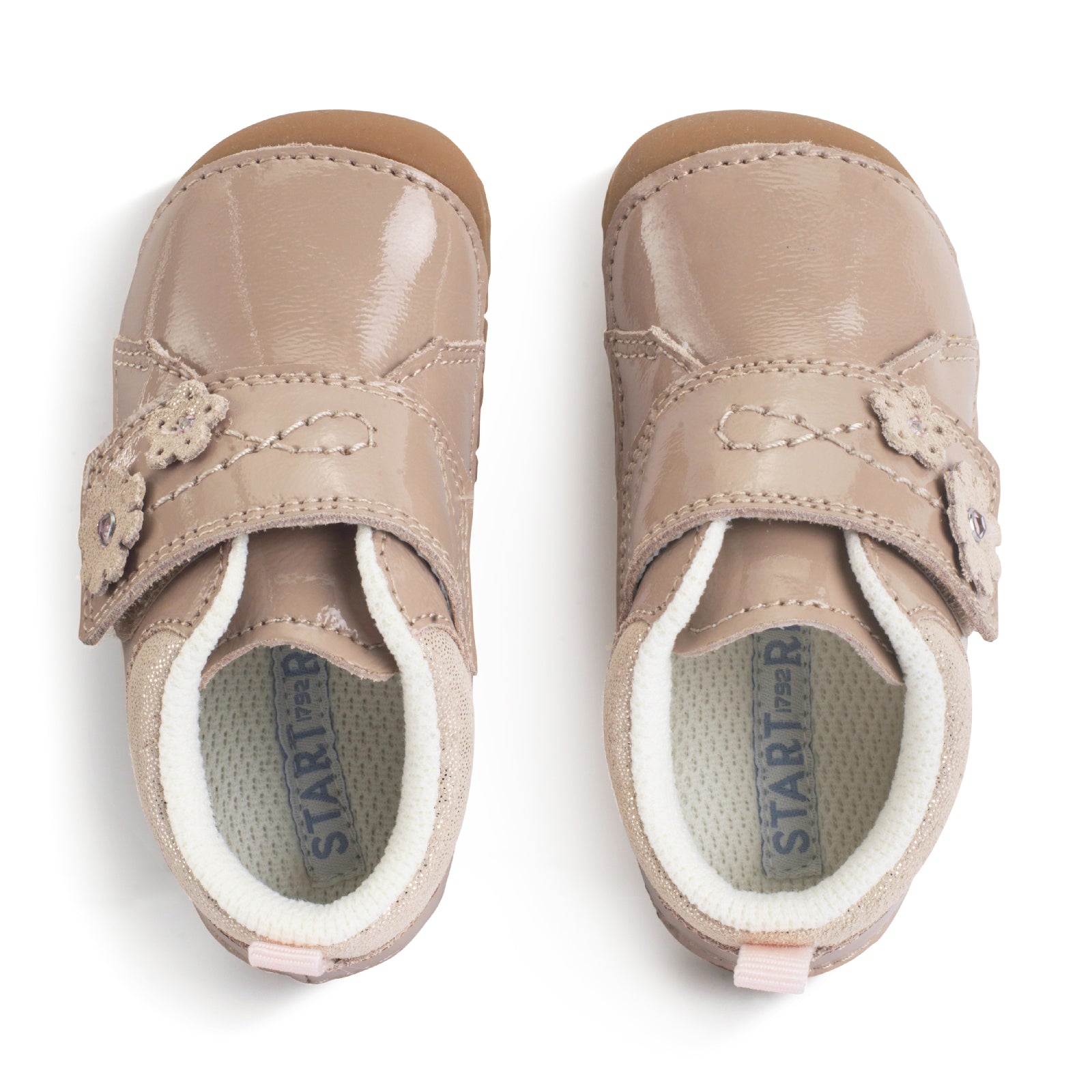 A girls shoe by Start-Rite, stye Lila, in taupe with heel and toe bumpers and wide velcro strap with flower design. Top view of pair