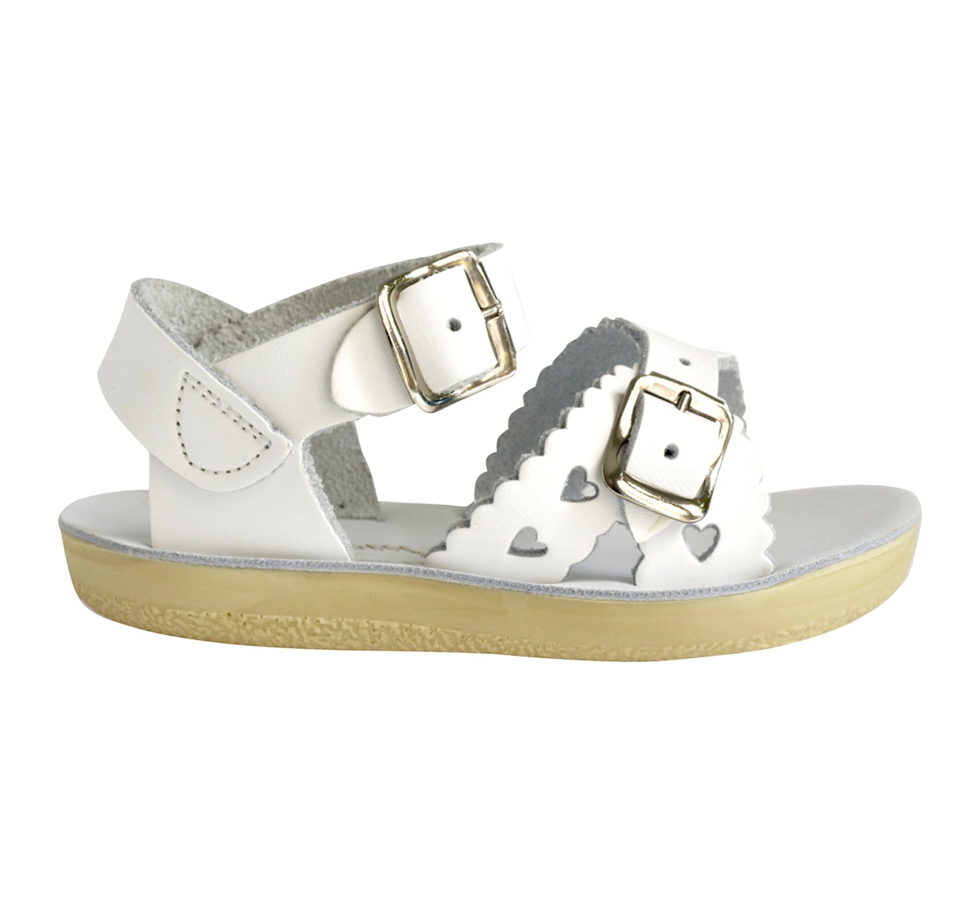 A girls sandal by Salt Water Sandal in white with double buckle fastening across the instep and around the ankle. Featuring scallop edge and punched out heart detail. Right Sideview.