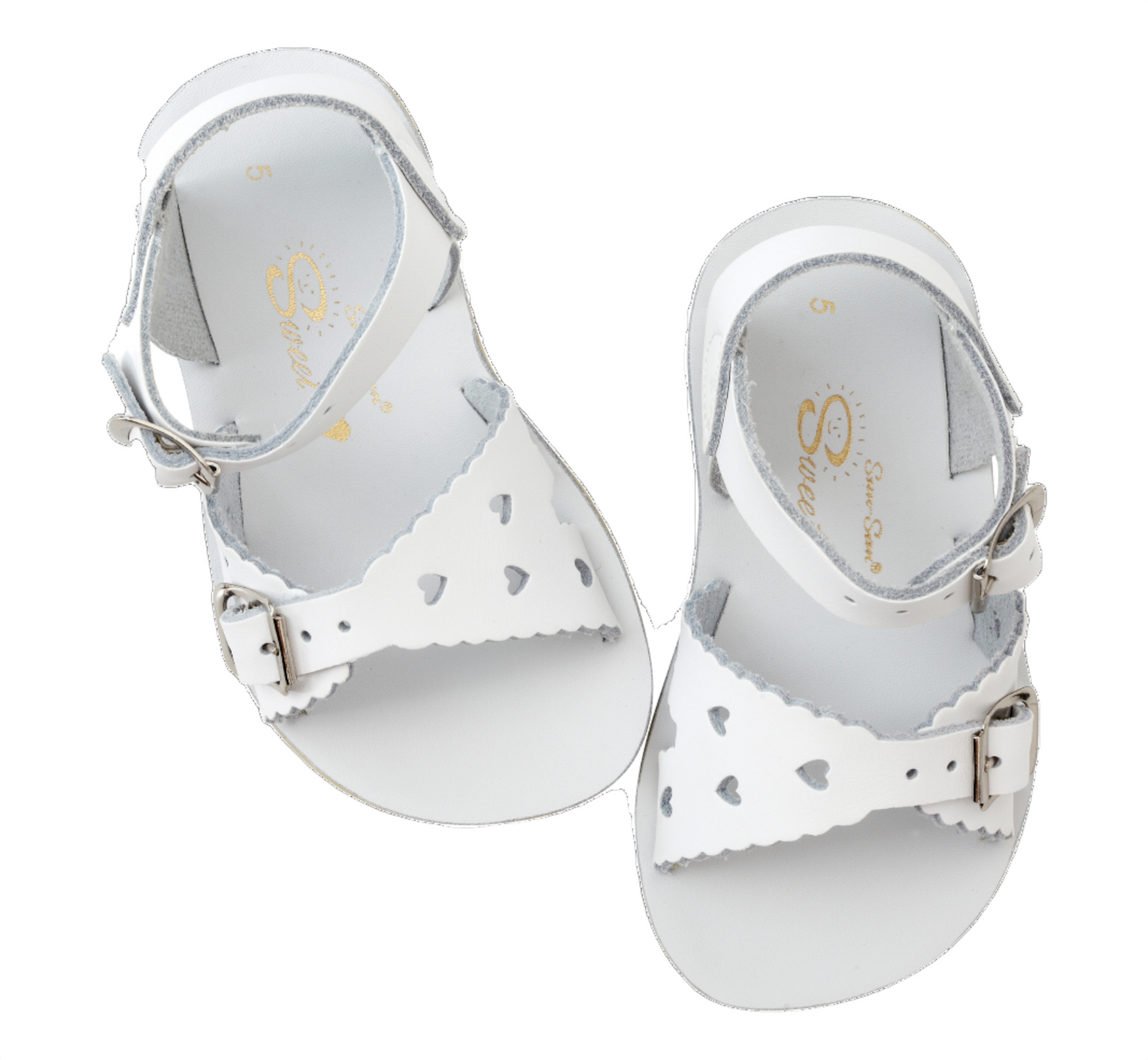 A girls sandal by Salt Water Sandal in white with double buckle fastening across the instep and around the ankle. Featuring scallop edge and punched out heart detail. Top view.