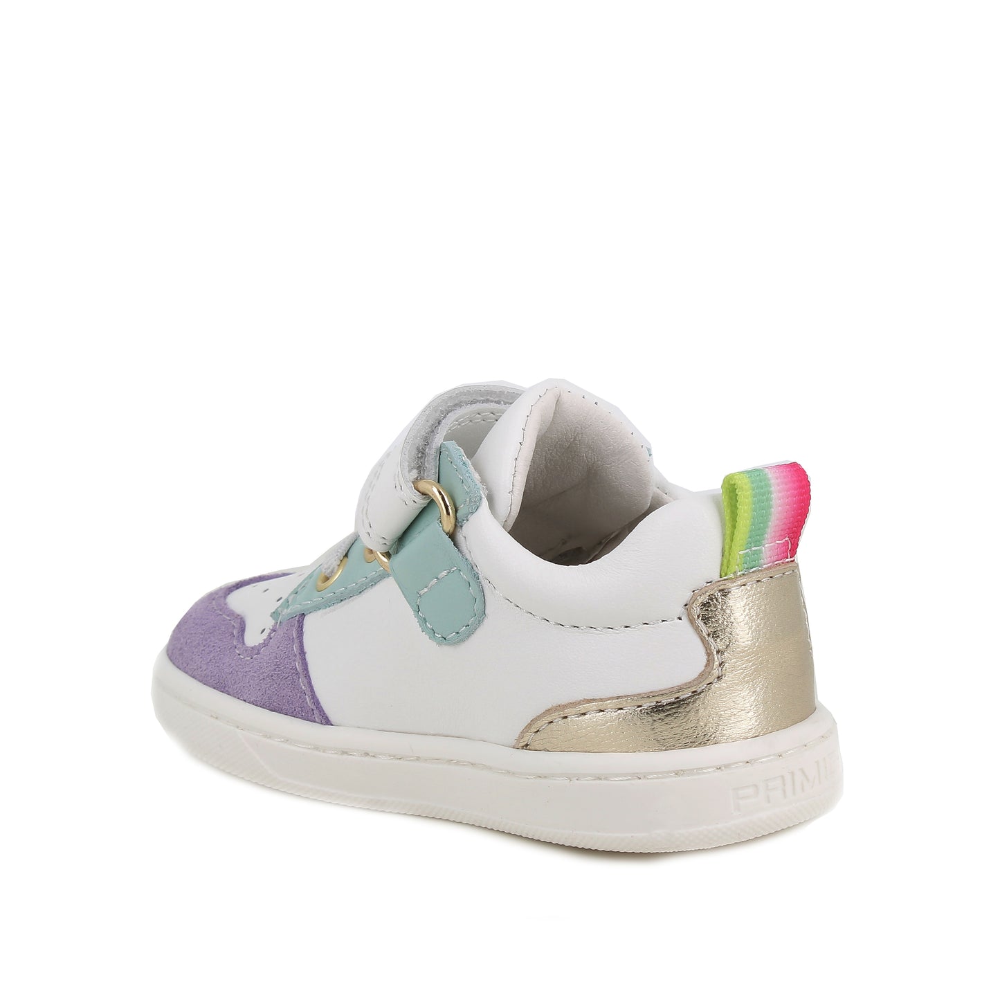 A girls casual trainer by Primigi, style Baby Like in white/iris with elastic laces and velcro strap. Rainbow stripe detail onside purple toe bumper pattern, and metallic design on heel. Two small pink love hearts on white sole. Angled back view.