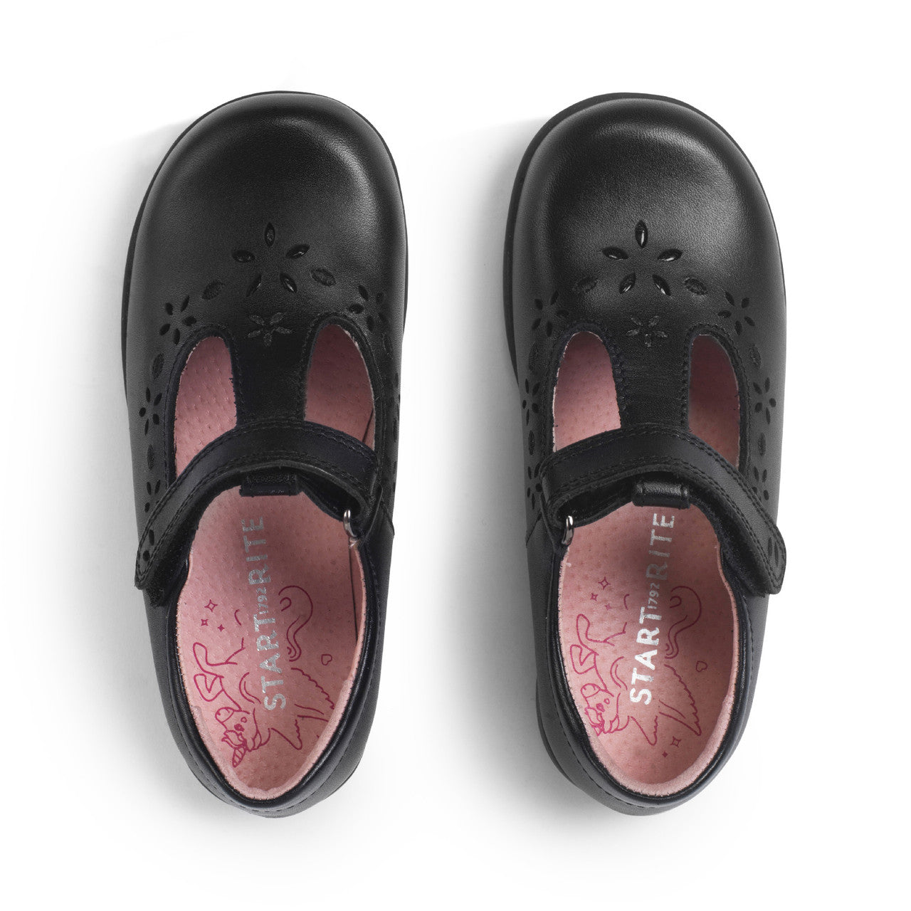 A girls T-bar school shoe by Start-Rite, style Charlotte in black leather with floral punch out detail and velcro fastening. View of pair from above.