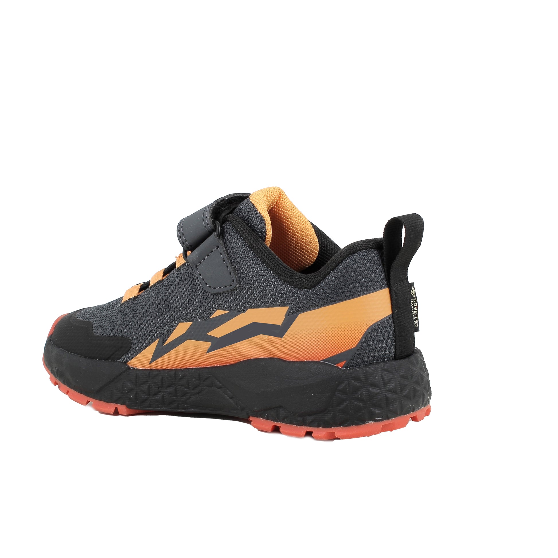 Boy's Primigi trainer in the style Storm GTX in black and orange with a Velcro strap and orange sole. Angled back view of right shoe. 
