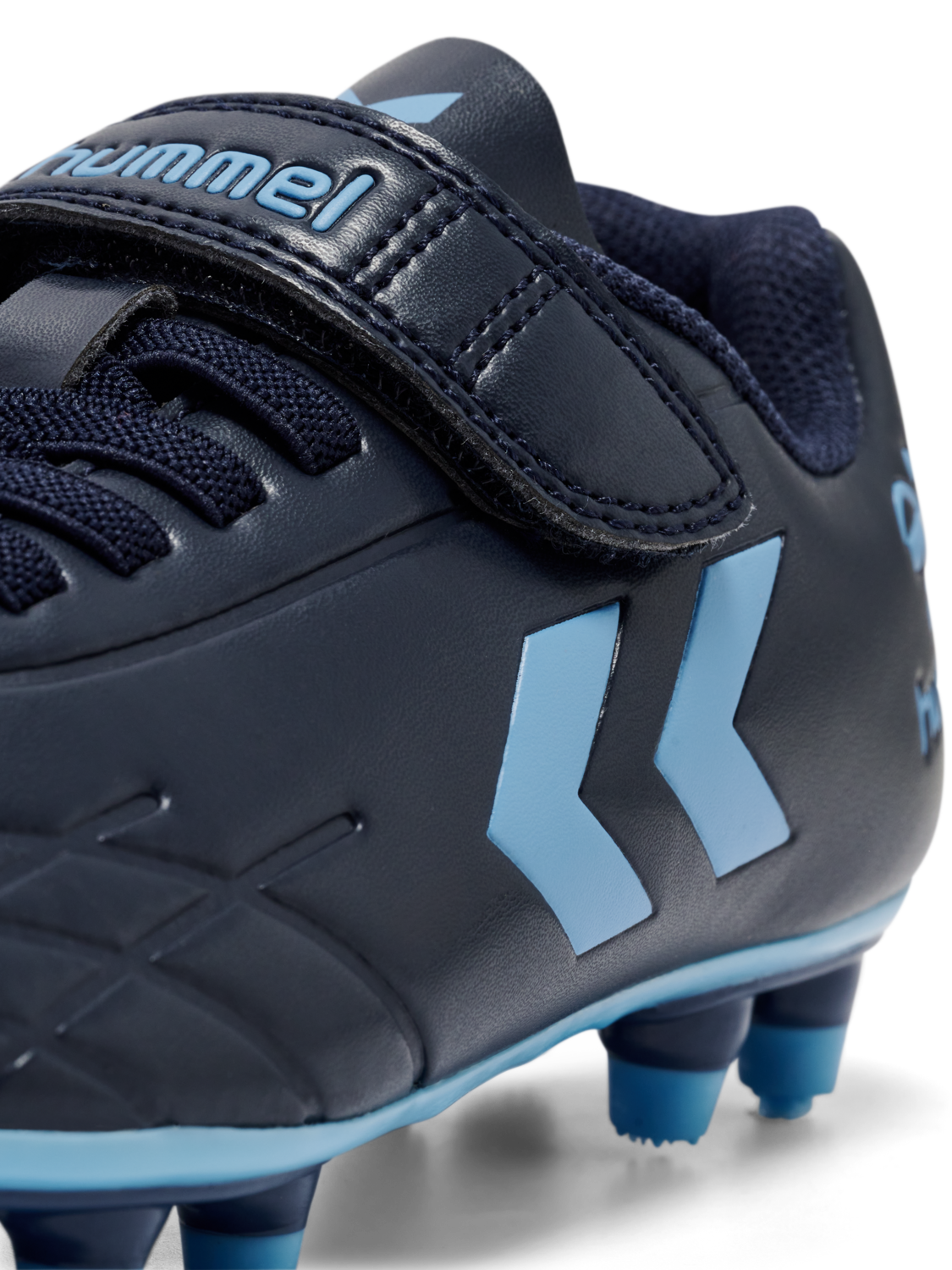 A firm ground football boot by Hummel, style Top Star F.G JR 216568-7381, in navy and blue with velcro fastening. Close up angled right side view.
