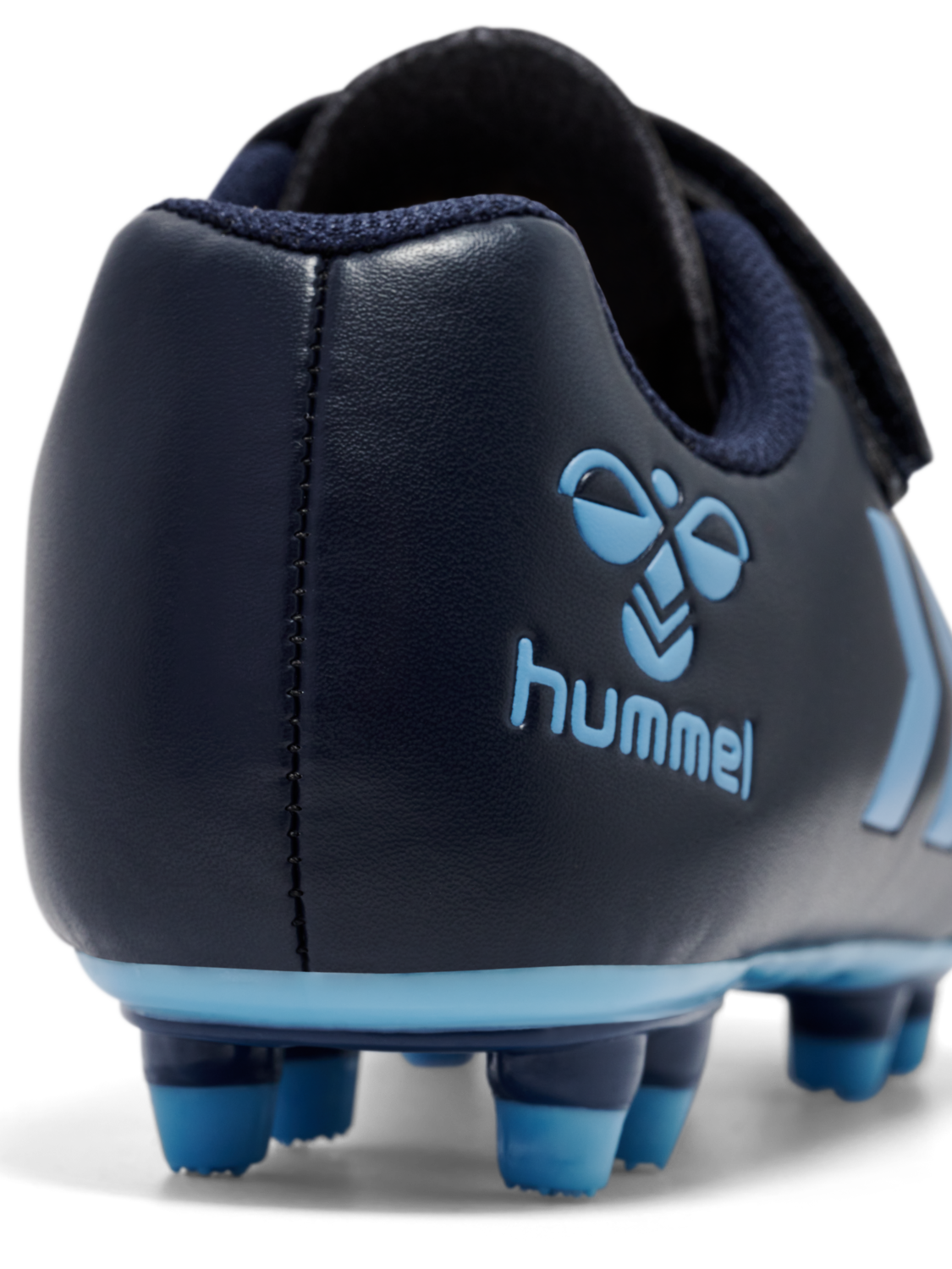 A firm ground football boot by Hummel, style Top Star F.G JR 216568-7381, in blue with velcro fastening. Close up heel view.