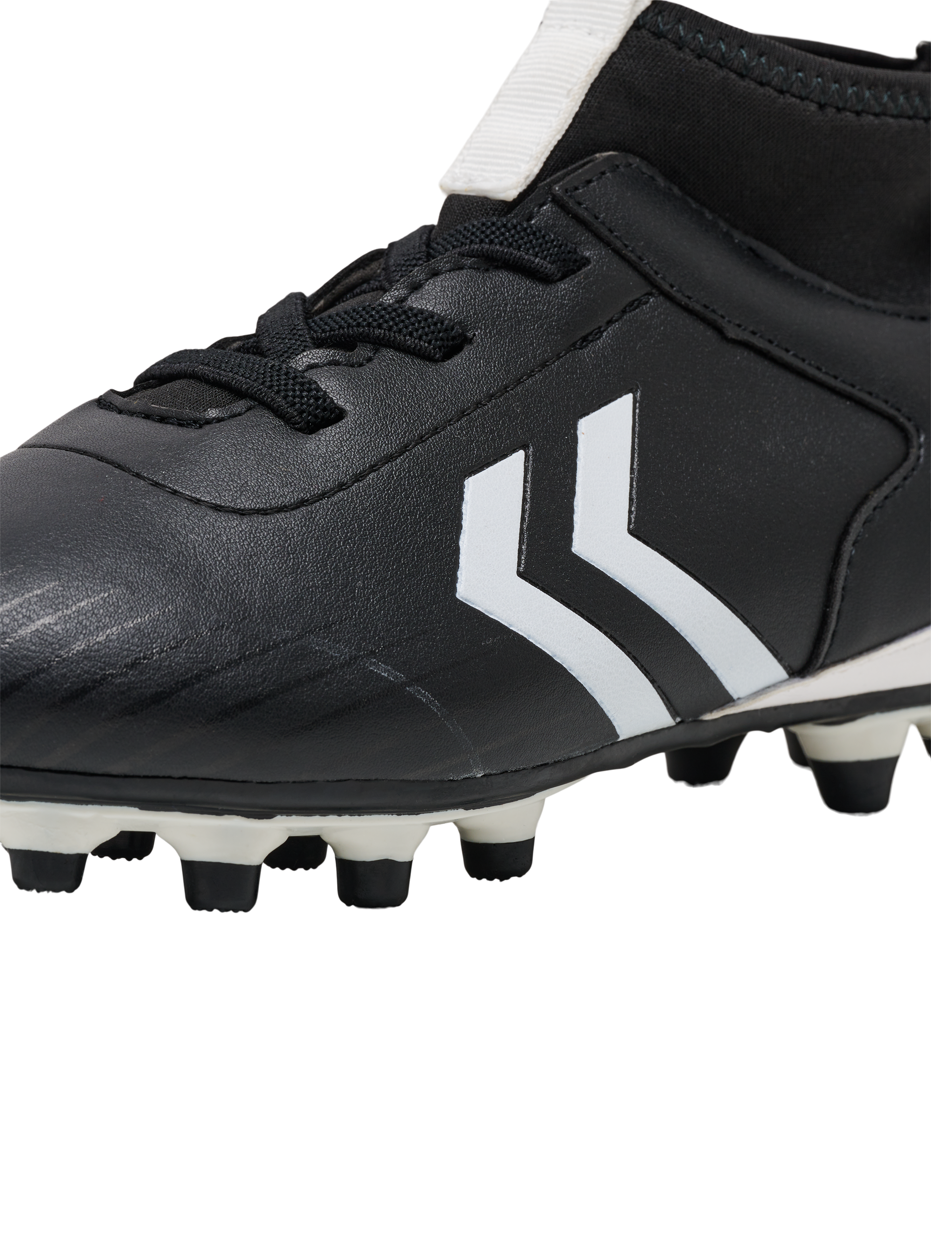 A boys firm ground football boot by Hummel, style Prestige MG JR 216569-2001, in black and white with sock insert and elastic lace fastening. Close up view.