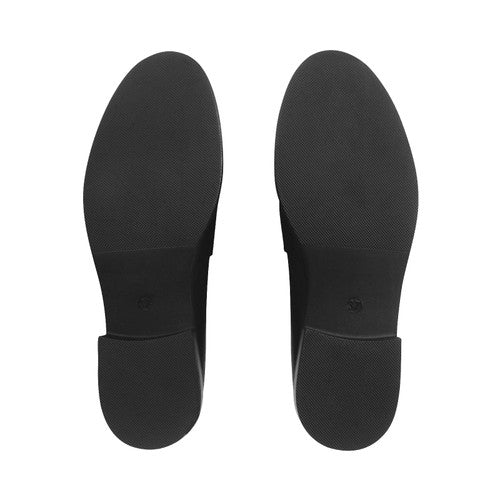 A girls slip on school school shoe by Start Rite, style Milan, in black leather with small heel. View of soles of a pair.