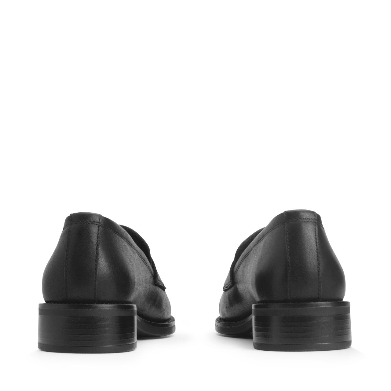 A girls slip on school school shoe by Start Rite, style Milan, in black leather with small heel. Back view of a pair.