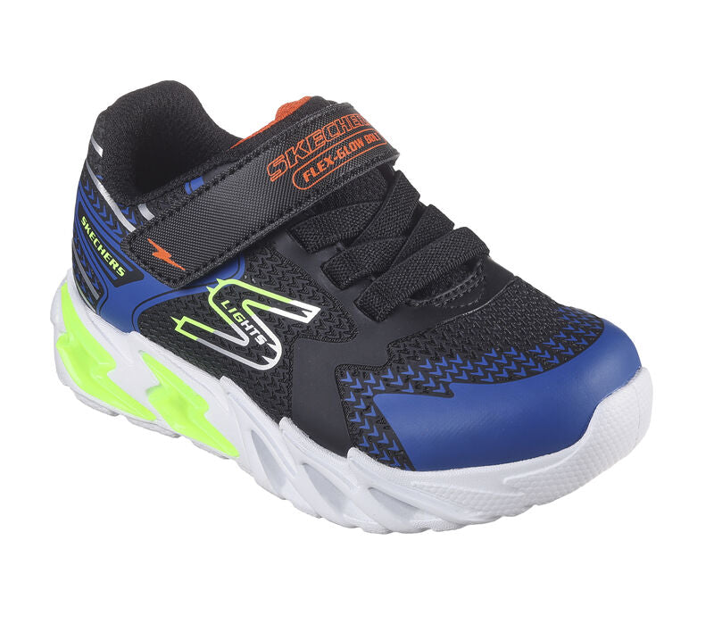 A boys light up trainer by Skechers, style Tri-Namics, in black yellow and blue synthetic with bungee lace and velcro fastening. Angled view.