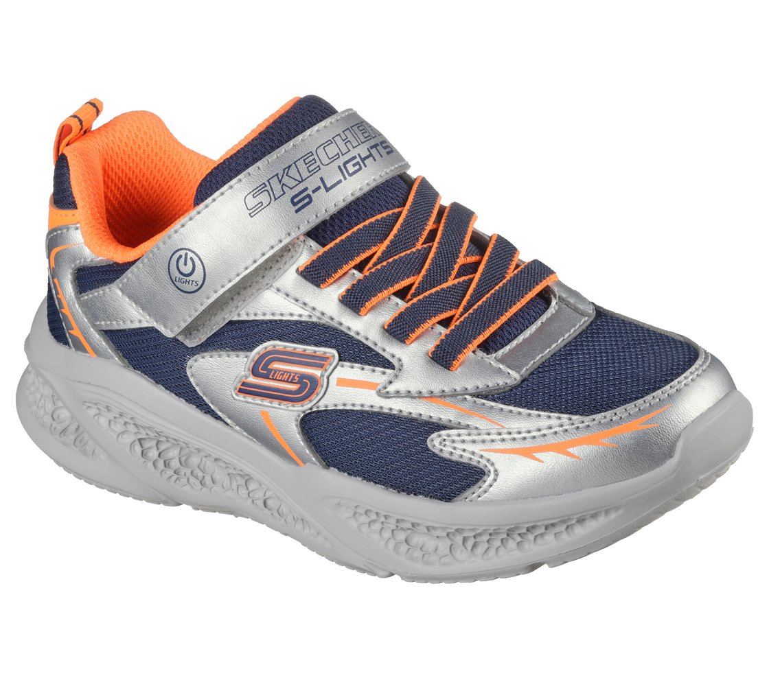 A boys casual trainer by Skechers, style Meteor Lights Glow Strider 401497L, in silver, navy and orange with light up sole and velcro fastening. Right side angled view.