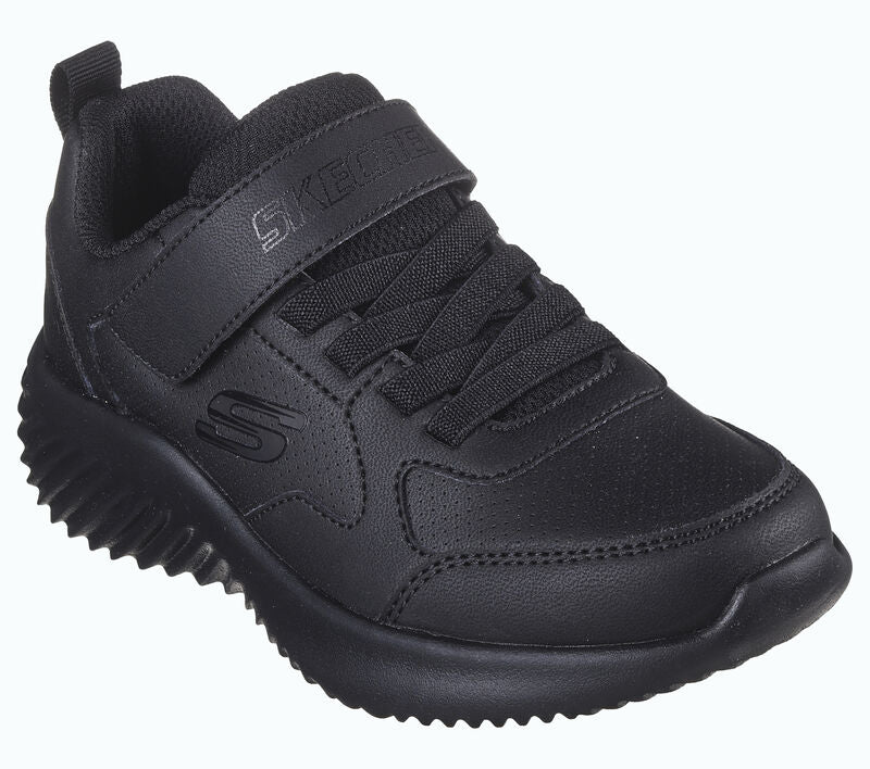 A unisex trainer by Skechers, style Power Study, in black synthetic with single velcro fastening. Angled view.