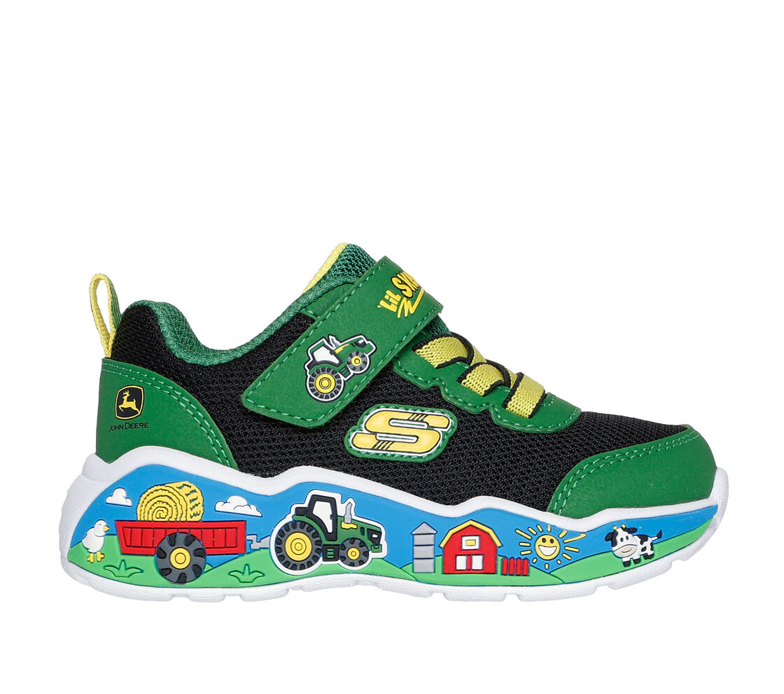 A boys trainer by Skechers, style Play Scene Barn Squad, in green and black set on blue sole with farm yard  motifs. Velcro and elastic lace fastening. Right side view.