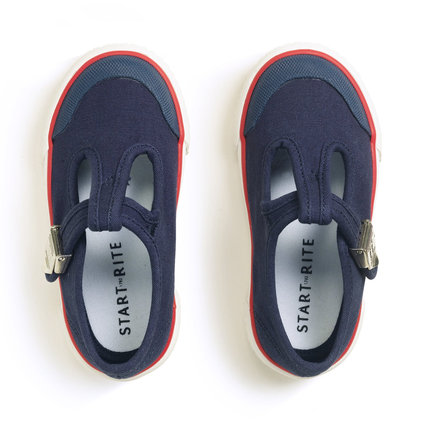 A pair of unisex canvas T-Bar shoes by Start-Rite, style Anchor, in navy, with white sole and red trim and silver buckle fastening. Above view.