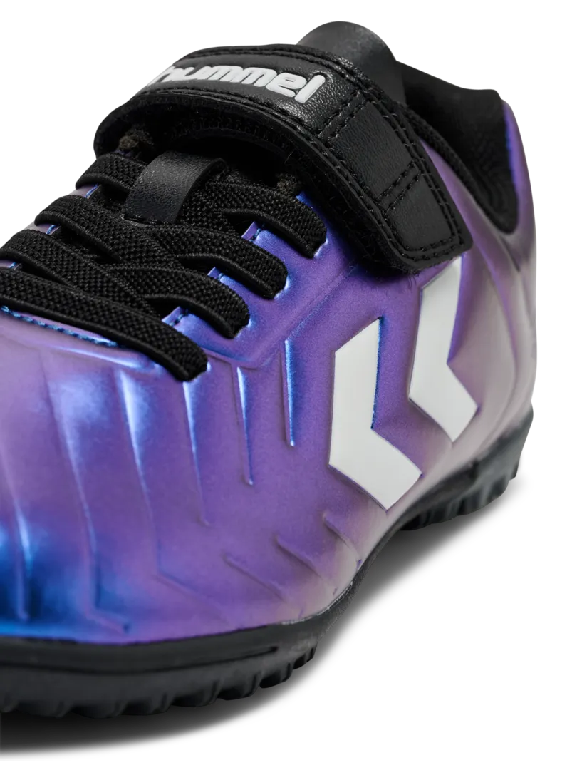 A hard ground/astro turf football boot by Hummel, style Top Star Turf VC 2.0 JR 234863-9639 in White Multi with velcro strap and elastic laces. Zoomed image of branding