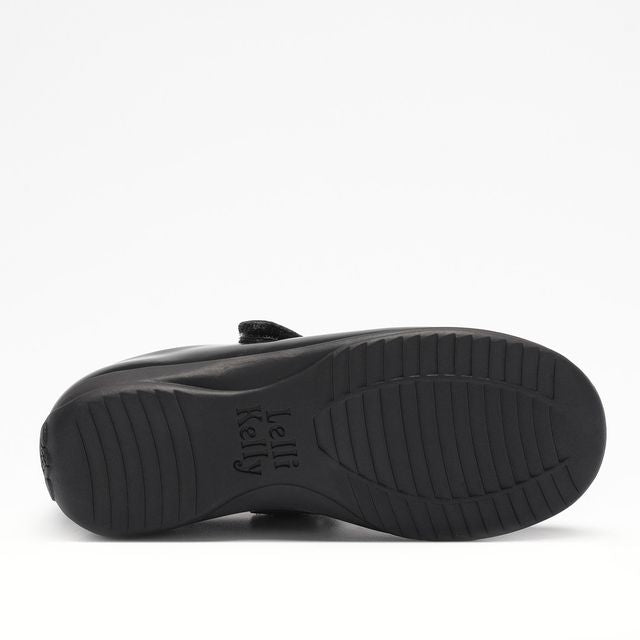 A girls Mary Jane school shoe by Lelli Kelly, style LKSO8467CVR Sabrina, in black patent with detachable heart embellished attachment. Velcro fastening. View of sole.