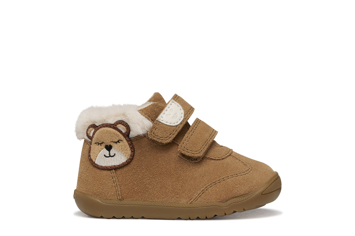 Geox suede ankle boot in brown, with two Velcro straps, bear detailing, fur lining and a tan rubber sole. Right side view.