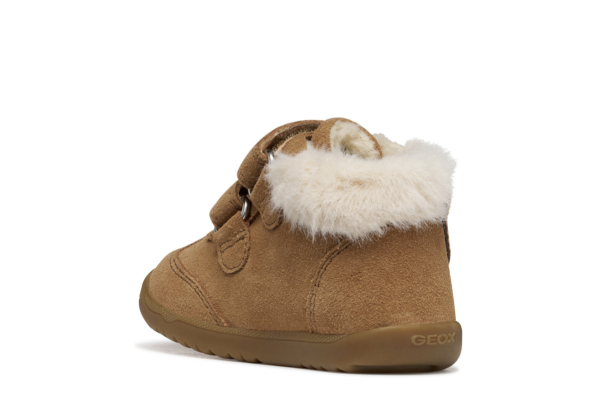 Geox suede ankle boot in brown, with two Velcro straps, bear detailing, fur lining and a tan rubber sole. Angled back view of right shoe. 