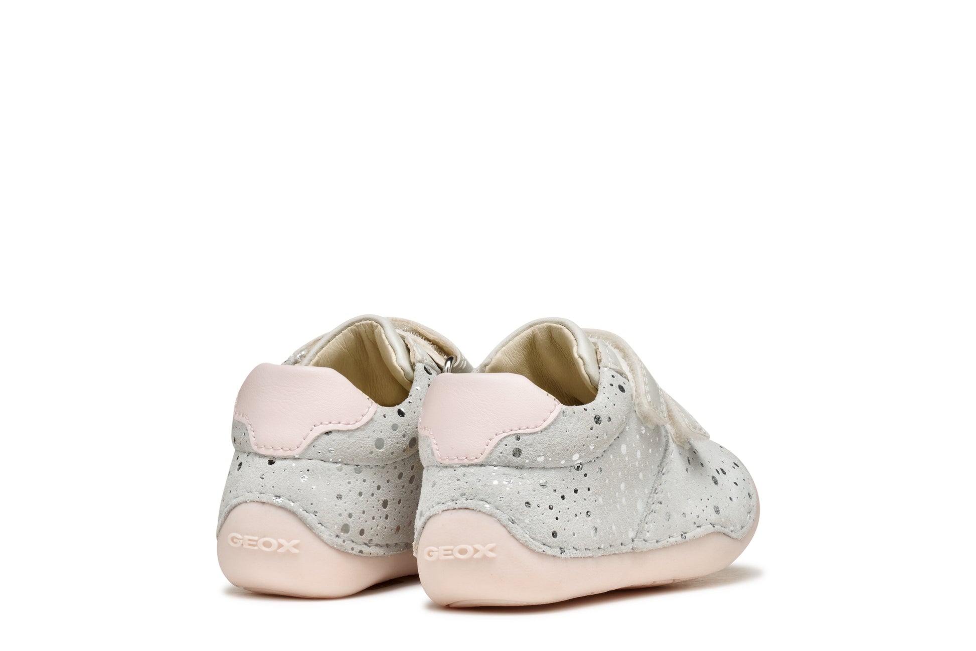 A girls pre-walker shoe by Geox, style Tutim in white/pink with silver speckled design, two velcro straps and toe and heel bumpers. Back view of pair