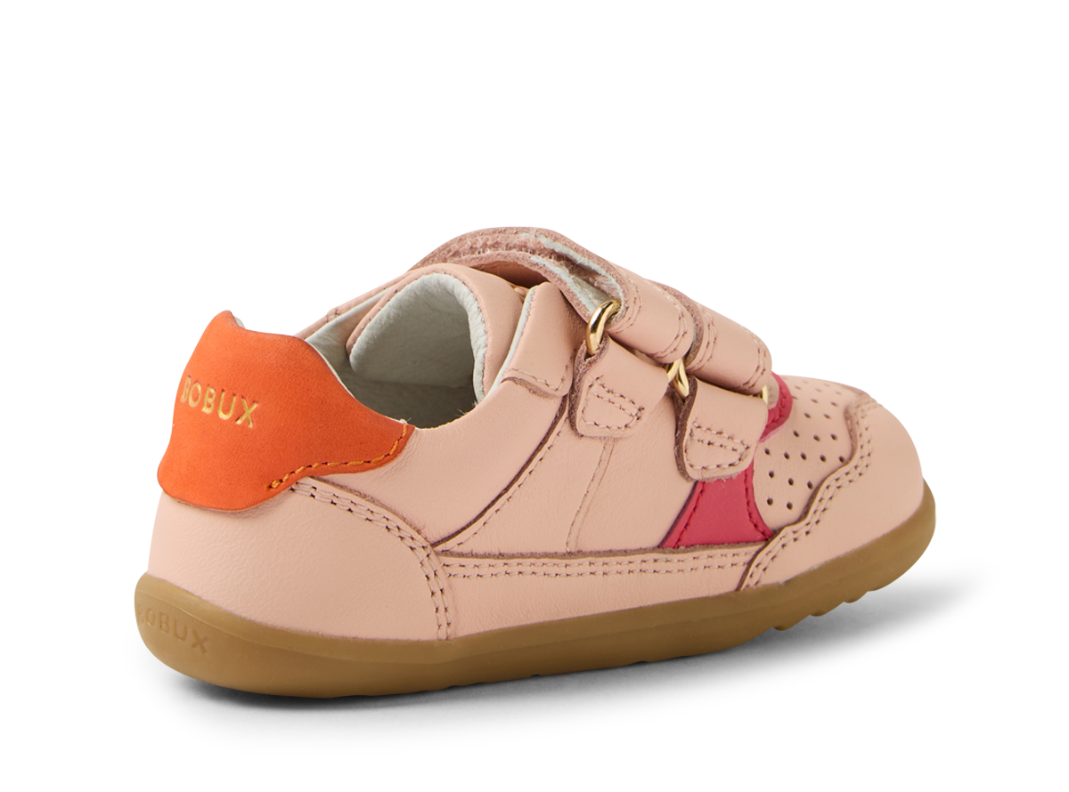 A girls casual shoe by Bobux, style Hunter in pink with bright pink and orange trim and velcro fastening. Angled left side view.