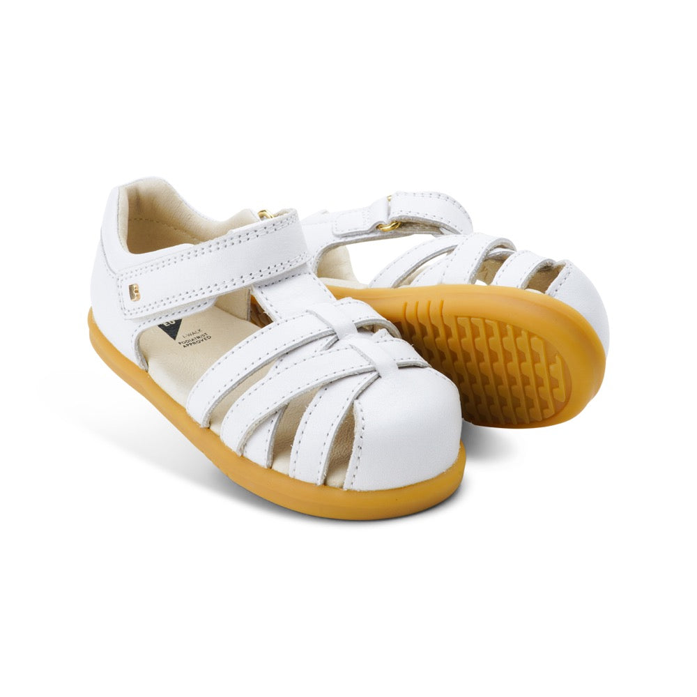A unisex sandal by Bobux, style Roam (I-Walk) in Caramel with velcro strap. View of pair with one sole showing