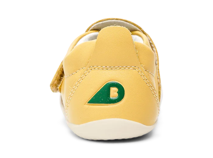 A unisex pre-walker by Bobux, style XP Go, in sand with velcro strap. View of the back featuring green bobux logo.
