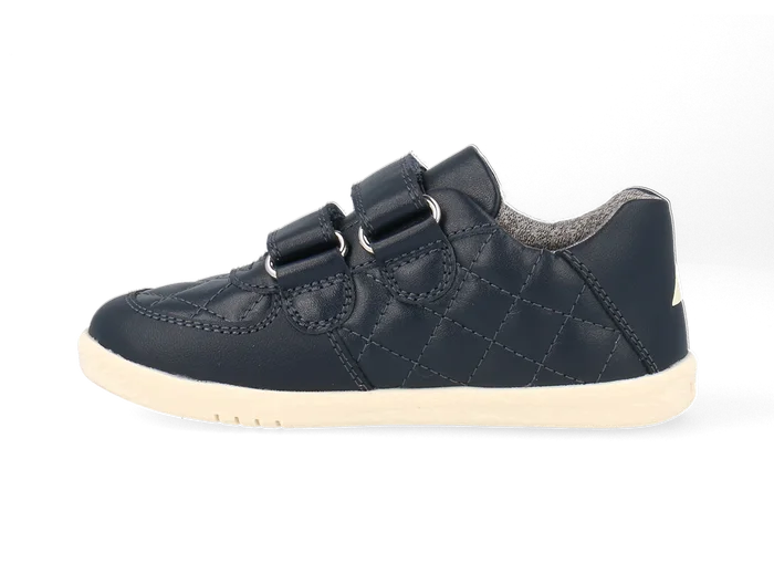 A boys casual shoe by Bobux, style Stitch, in navy leather ,with stitch detail and double velcro fastening. Left side view.