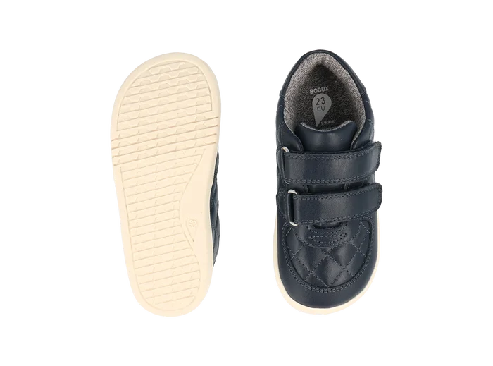 A pair of boys casual shoes by Bobux, style Stitch, in navy leather ,with stitch detail and double velcro fastening. View from above of sole and top of shoes.