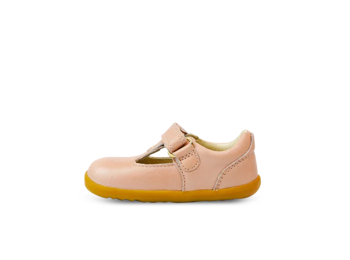 A girls first shoe by Bobux, style Louise, a velcro T-bar in dusky pink pearl. Inner side view.