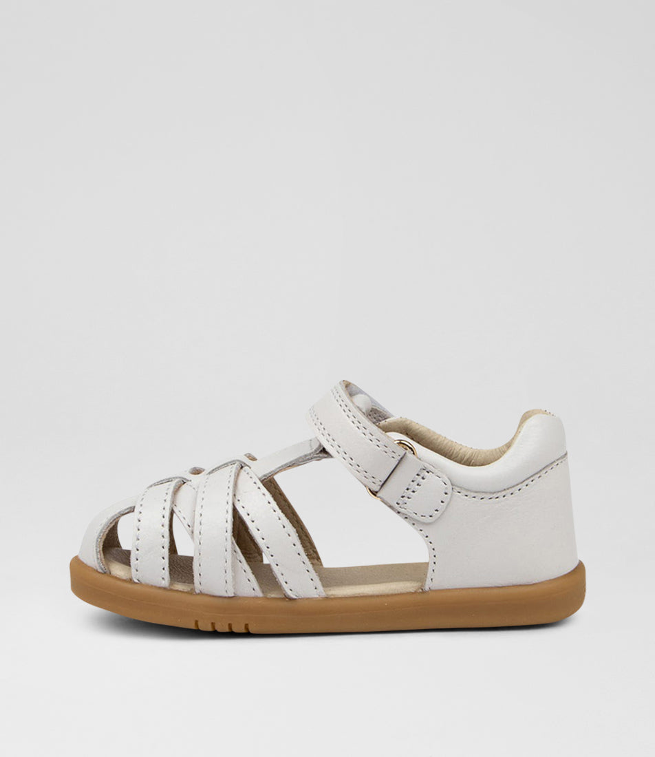 A unisex sandal by Bobux, style Cross Jump in white with velcro strap and light brown sole. Inner right side view