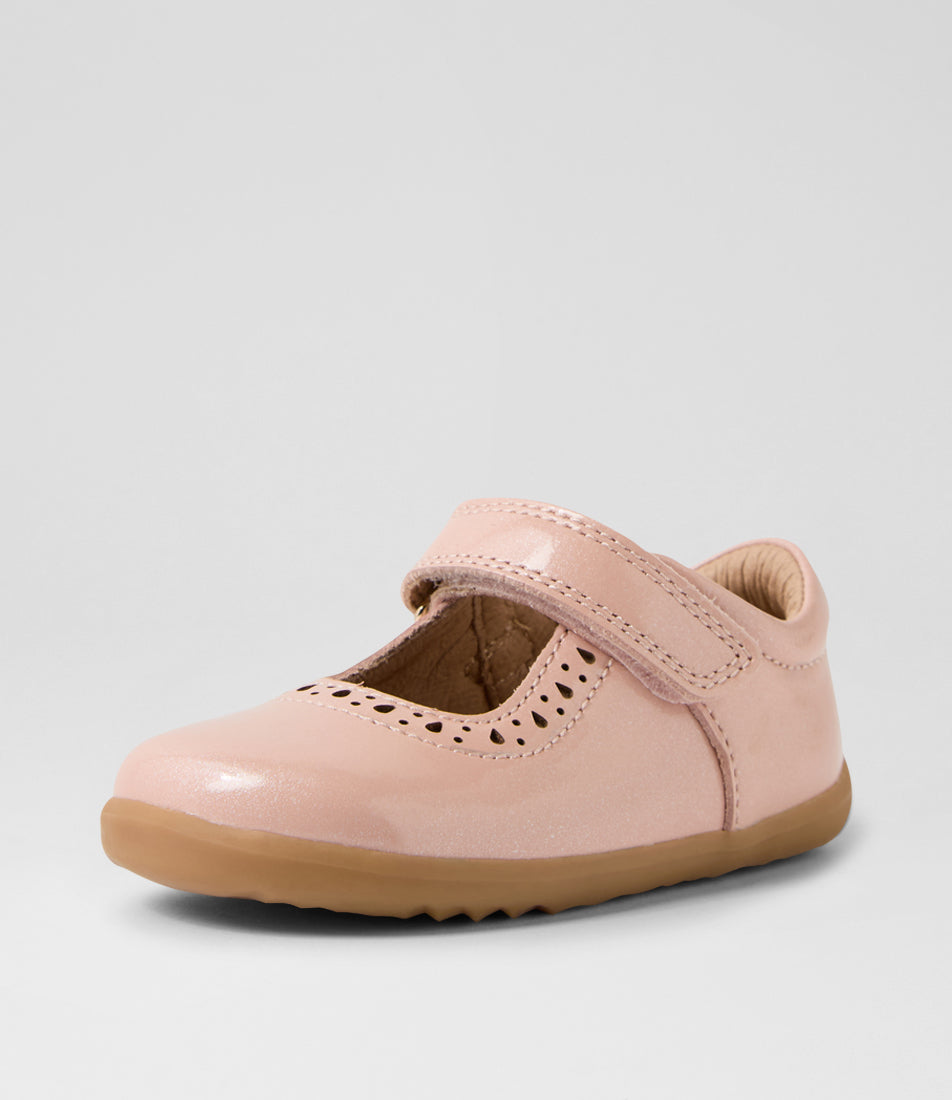 A girls casual shoe by Bobux, style Lola in Cameo Rose with velcro strap, cut out pattern detail and light brown sole. Angled front view