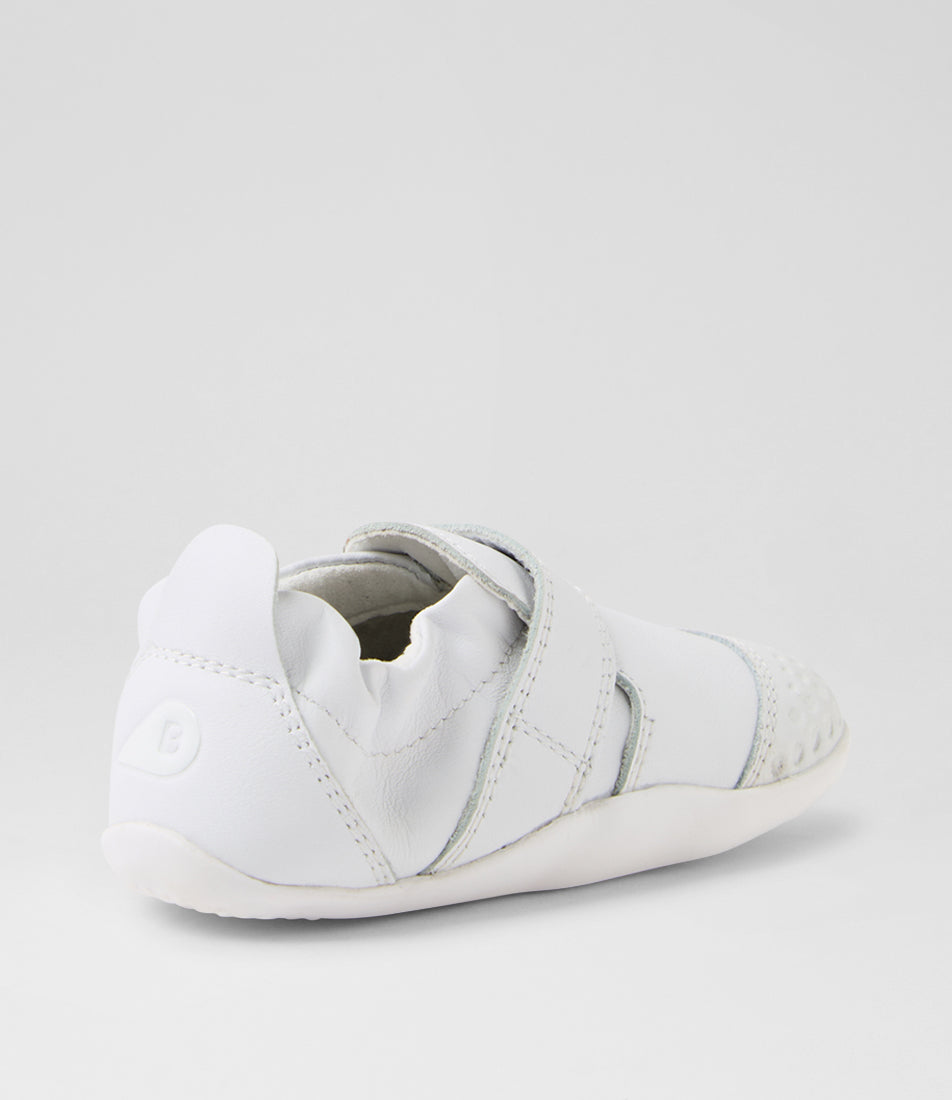 A unisex pre-walker shoe by Bobux, style Xplorer in white. With a velcro strap and front toe bumper. Back view