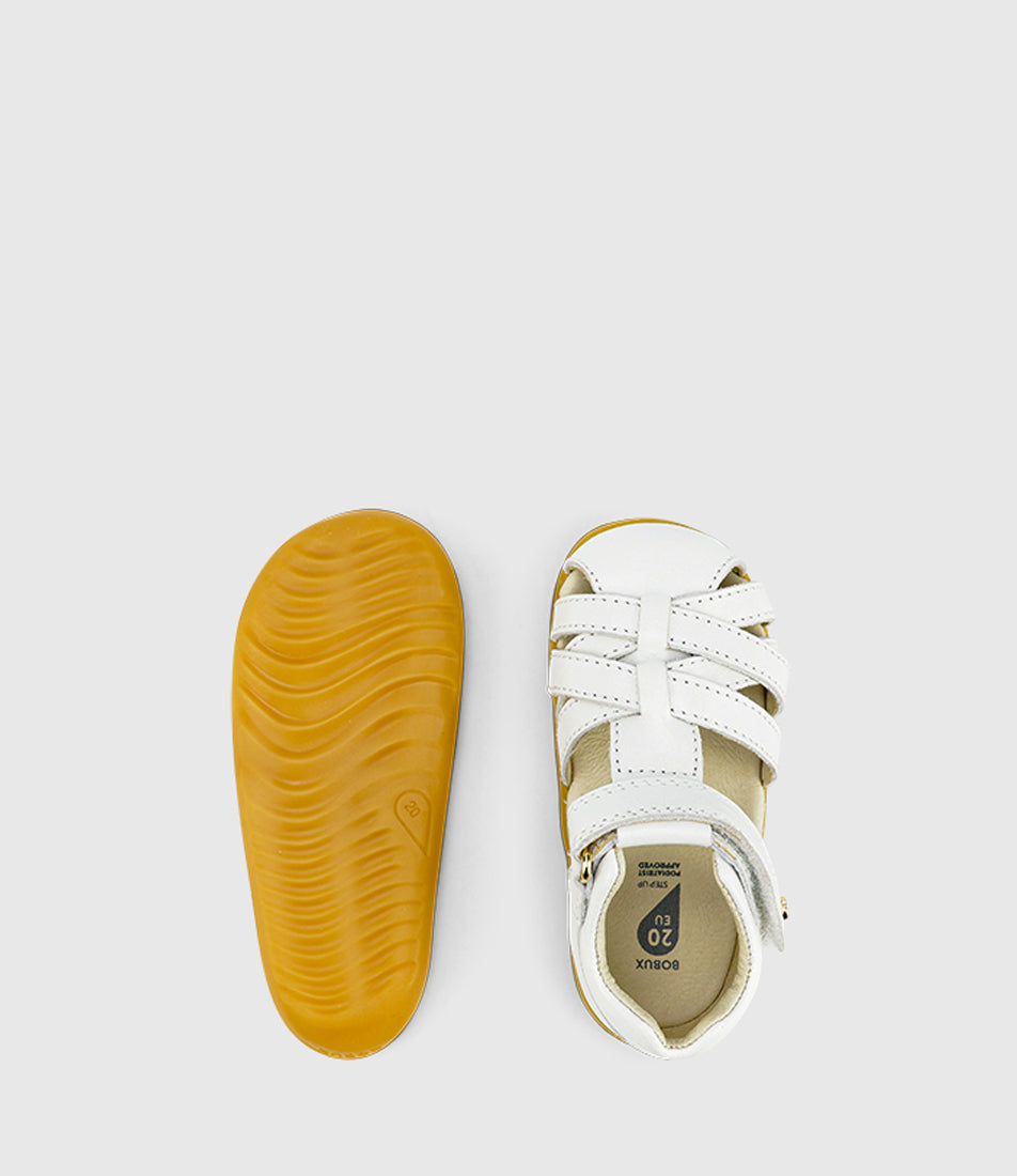 A unisex sandal by Bobux, style Roam (I-Walk) in Caramel with velcro strap. View of pair with one sole 