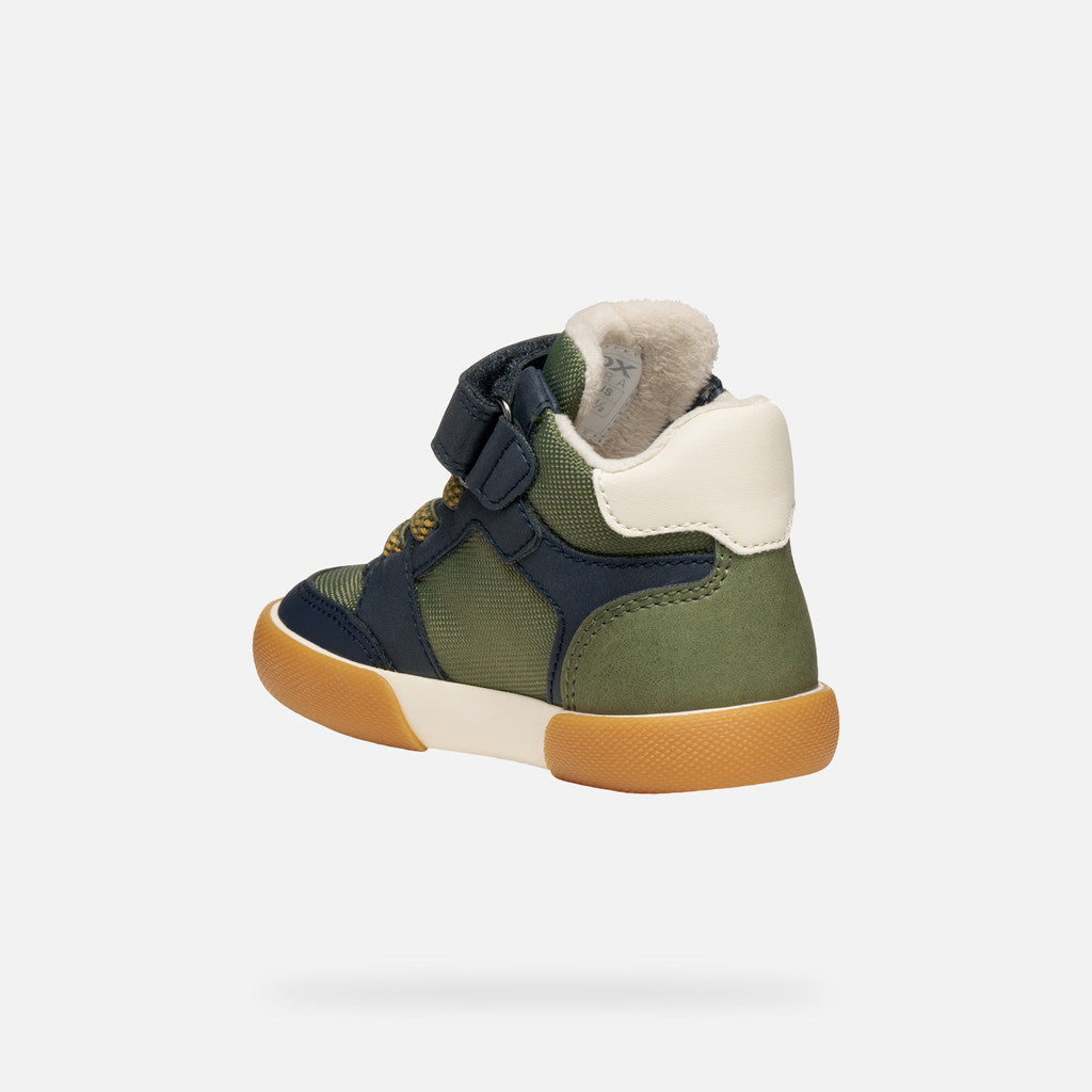 A boys ankle boot by Geox, style Gisli Boy A, in military/navy with velcro strap and green/yellow laces. Angled inner back view